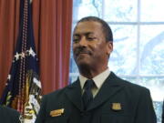 FILE - In this July 10, 2015, file photo Randy Moore, of the U.S. Forest Service, listens as President Barack Obama talks about the designation of three new national monuments in the Oval Office of the White House in Washington. Veteran forester Randy Moore has been named chief of the U.S. Forest Service, the first African American to lead the agency in its 116-year history.