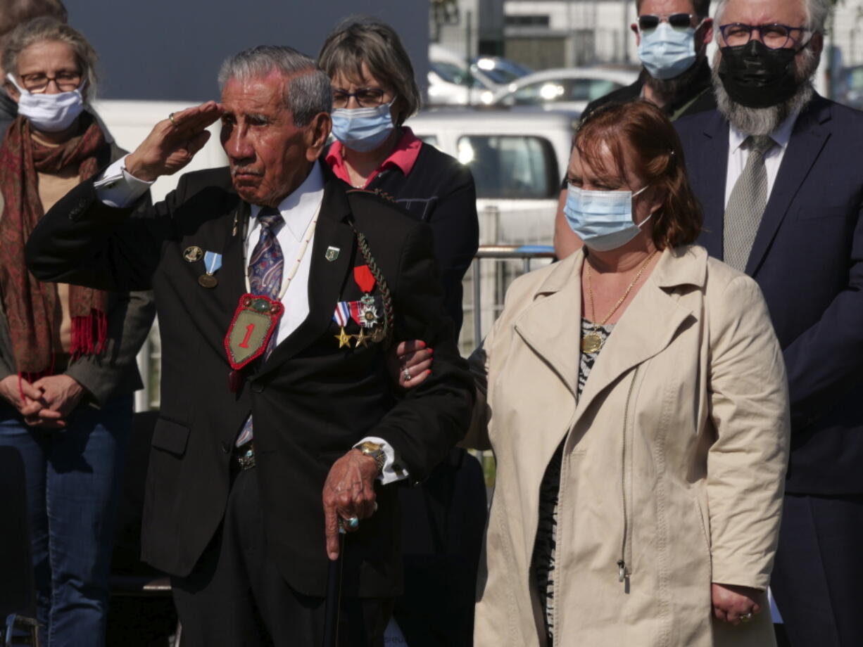 Charles Shay, the 96-year-old native American from Indian Island, Maine, salutes during a D-Day ceremony in Carentan, Normandy, Friday, June 4, 2021. In a small Normandy town where paratroopers landed in the early hours of D-Day, applauds broke the silence to honor Charles Shay. He was the only veteran to attend the ceremony in Carentan commemorating the 77th anniversary of the assault that led to the end World War II. Shay was a 19-year-old U.S. Army medic when he landed on Omaha Beach.