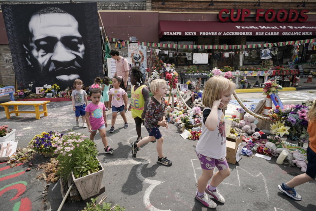 Preschool children visit the site where George Floyd was murdered by then Minneapolis Police officer Derek Chauvin, as the kids took a field trip to the memorial, Thursday, June 24, 2021, in Minneapolis. Chauvin is scheduled to be sentenced on Friday.