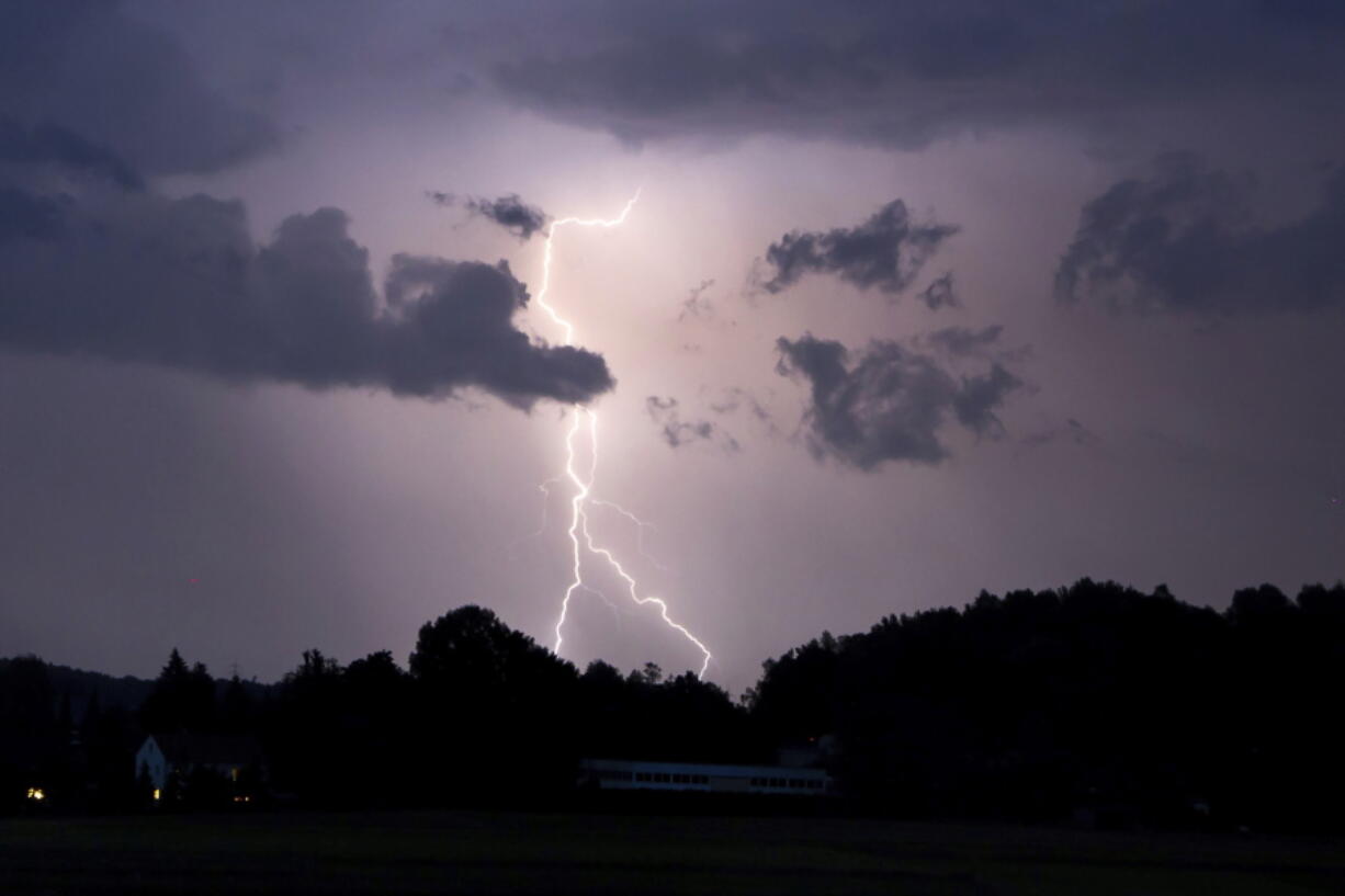 Lightning lights up the night sky In Neumarkt, Germany, Sunday, June 20, 2021. Heavy rains and thunderstorms have caused flooded cellars and streets as well as fallen trees and a variety of property damage in Central and Upper Franconia in the night to Monday.