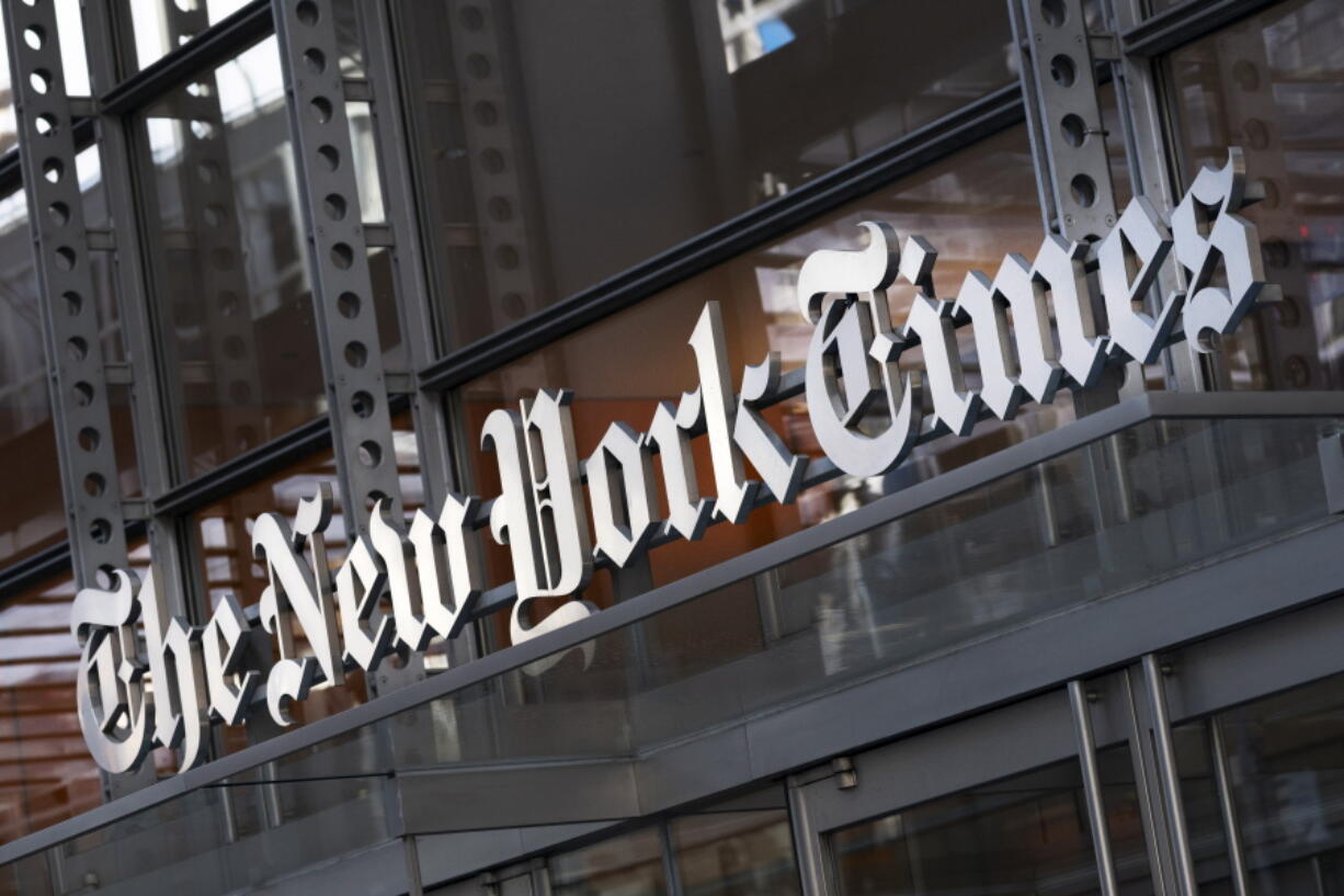 FILE - In this Thursday, May 6, 2021 file photo, a sign for The New York Times hangs above the entrance to its building, in New York. Numerous websites were unavailable on Tuesday June 8, 2021, after an apparent widespread outage at cloud service company Fastly. Dozens of high-traffic websites including the New York Times, CNN, Twitch and the U.K. government's home page, could not be reached.