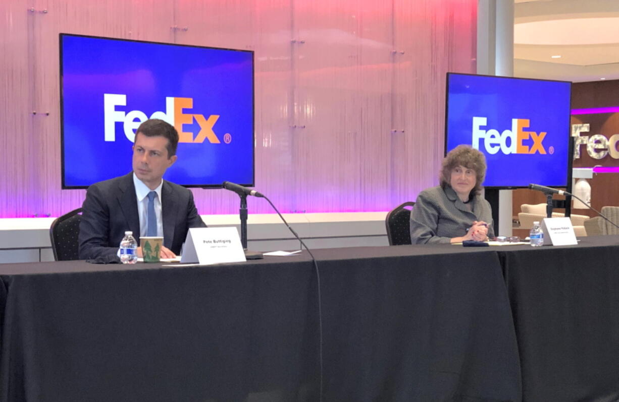 U.S. Department of Transportation Secretary Pete Buttigieg, left, and Acting Administrator for the Federal Highway Administration Stephanie Pollack listen to a speaker during a discussion at a FedEx Corp. facility about the closure of the Interstate 40 bridge on Thursday, June 3, 2021, in Memphis, Tenn.