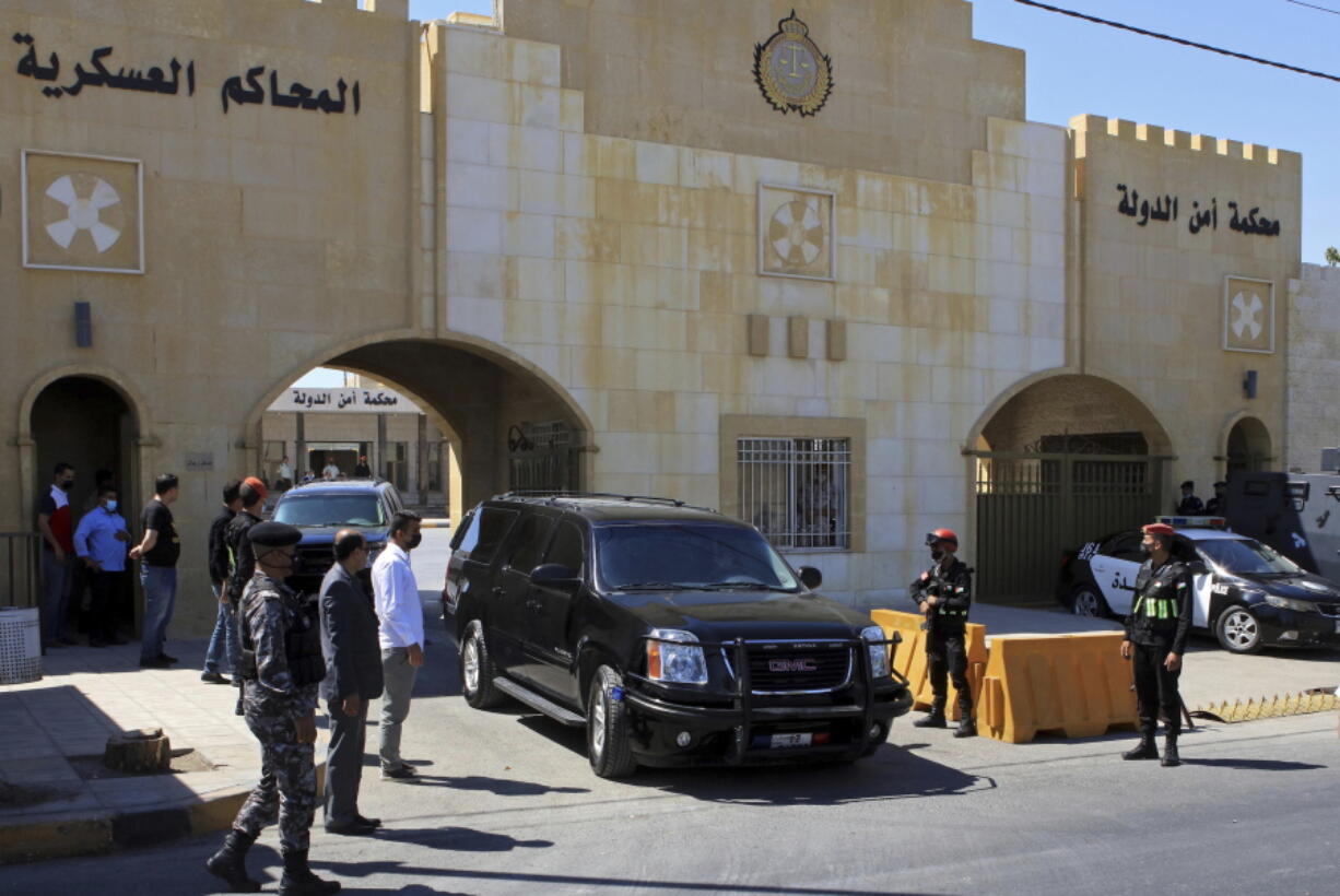 Bassem Awadallah, a former royal adviser, leaves a state security court in a vehicle after the first session of his trial, in Amman, Jordan, Monday, June. 21, 2021. Awadallah, who has Jordanian, U.S. and Saudi citizenship, and Sharif Hassan bin Zaid, a distant cousin of the king, pleaded not guilty Monday to sedition and incitement charges, a defense lawyer said.