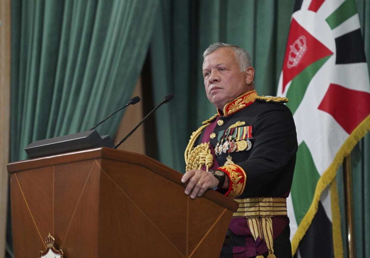 FILE - In this Dec. 10, 2020 file photo released by the Royal Hashemite Court, Jordan's King Abdullah II gives a speech to parliament, in Amman Jordan. Jordan's version of a trial of the century gets under way as early as Monday, June 21, 2021. A relative of King Abdullah II and a former chief of the royal court will be ushered into the defendants' cage at the state security court to face sedition charges. They are accused of conspiring with Prince Hamzah, a half-brother of the king, to foment unrest against the monarch.