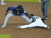 Detroit Tigers' Derek Hill safely beats the tag of Seattle Mariners second baseman Shed Long Jr. for a steal during the fifth inning of a baseball game, Tuesday, June 8, 2021, in Detroit.