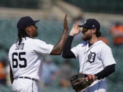 Detroit Tigers relief pitcher Gregory Soto (65) greets left fielder Eric Haase after the team's 8-3 win over the Seattle Mariners in a baseball game, Thursday, June 10, 2021, in Detroit.