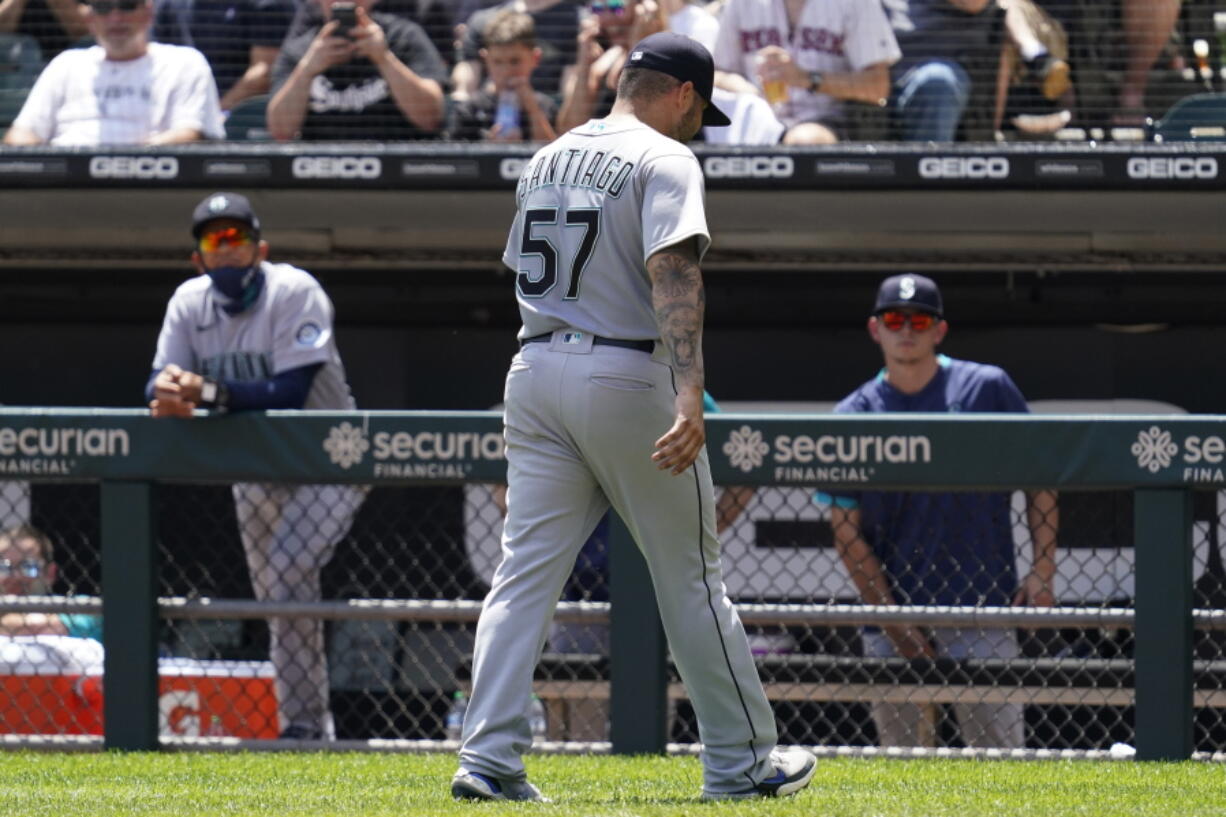 Seattle Mariners relief pitcher Hector Santiago walks to the dugout after he was ejected by home plate umpire Phil Cuzzi during the fifth inning in the first baseball game of a doubleheader against the Chicago White Sox in Chicago, Sunday, June 27, 2021. (AP Photo/Nam Y.