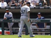 Seattle Mariners relief pitcher Hector Santiago walks to the dugout after he was ejected by home plate umpire Phil Cuzzi during the fifth inning in the first baseball game of a doubleheader against the Chicago White Sox in Chicago, Sunday, June 27, 2021. (AP Photo/Nam Y.