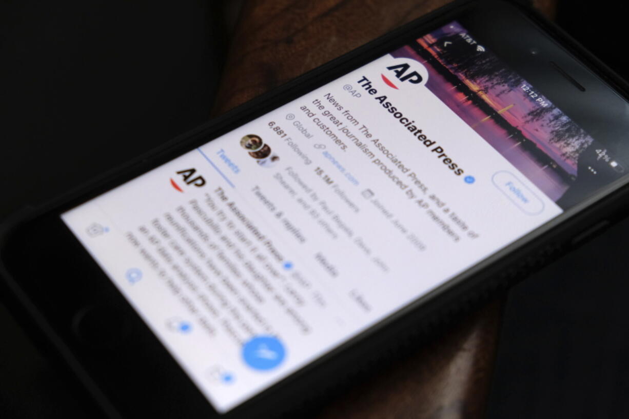 A cellphone displays The Associated Press Twitter account on Tuesday, June 8, 2021, in Los Angeles. The AP's recent firing of a young reporter for what she said on Twitter has somewhat unexpectedly turned company and industry attention to the flip side of social media engagement -- the online abuse that many journalists face routinely.