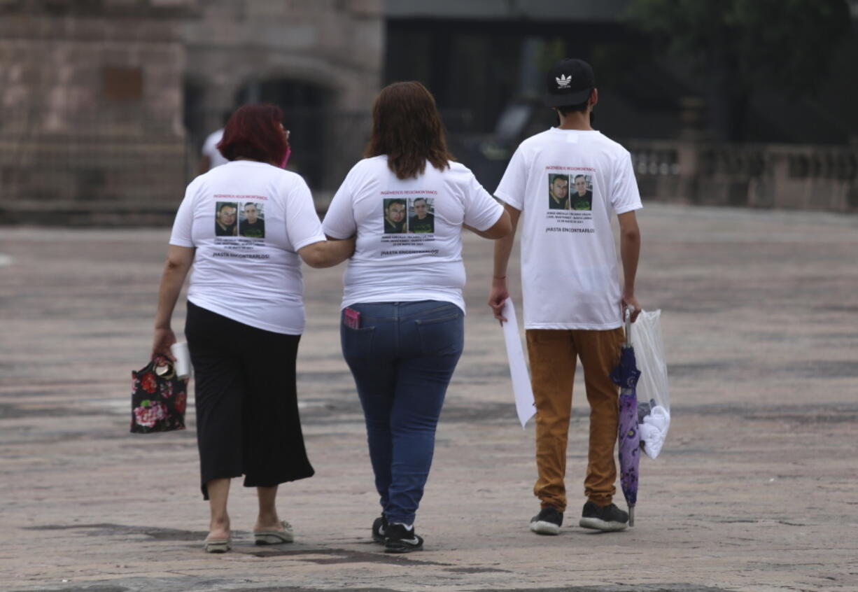 Family members wear T-shirts with photos of disappeared Jorge Arevelo and Ricardo Valdes, during a protest in Monterrey, Nuevo Leon state, Mexico, Thursday, June 24, 2021. As many as 50 people in Mexico are missing after they set off on simple highway trips between the industrial hub of Monterrey and the border city of Nuevo Laredo; relatives say they simply disappeared on the heavily traveled road, which has been dubbed 'the highway of death,' never to be seen again.