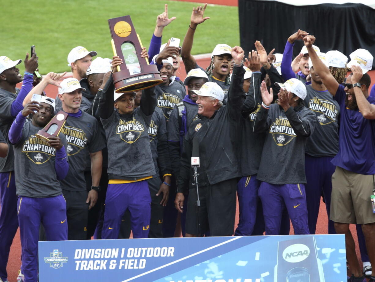 LSU athletes and coach Dennis Shaver, center, celebrate after LSU won the men's team title at the NCAA Outdoor Track and Field Championship in Eugene, Ore., Friday, .June 11, 2021.