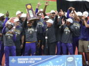 LSU athletes and coach Dennis Shaver, center, celebrate after LSU won the men's team title at the NCAA Outdoor Track and Field Championship in Eugene, Ore., Friday, .June 11, 2021.