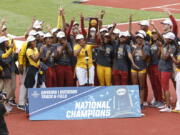 The Southern California women's team accepts the team trophy at the NCAA Division I Outdoor Track and Field Championships, Saturday, June 12, 2021, at Hayward Field in Eugene, Ore.