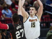 Denver Nuggets center Nikola Jokic shoots over Portland Trail Blazers center Jusuf Nurkic during the first half of Game 6 of an NBA basketball first-round playoff series Thursday, June 3, 2021, in Portland, Ore.