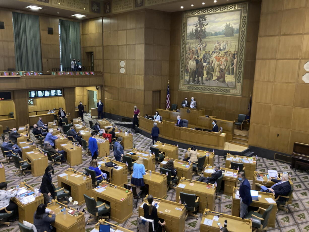 FILE - In this Thursday, June 10, 2021, file photo, The Oregon House of Representatives prepare to open an evening session in the Oregon Capitol in Salem, Ore. The Oregon Legislature worked Saturday, June 26, 2021 to wrap up its 2021 session, which was marked by the coronavirus.