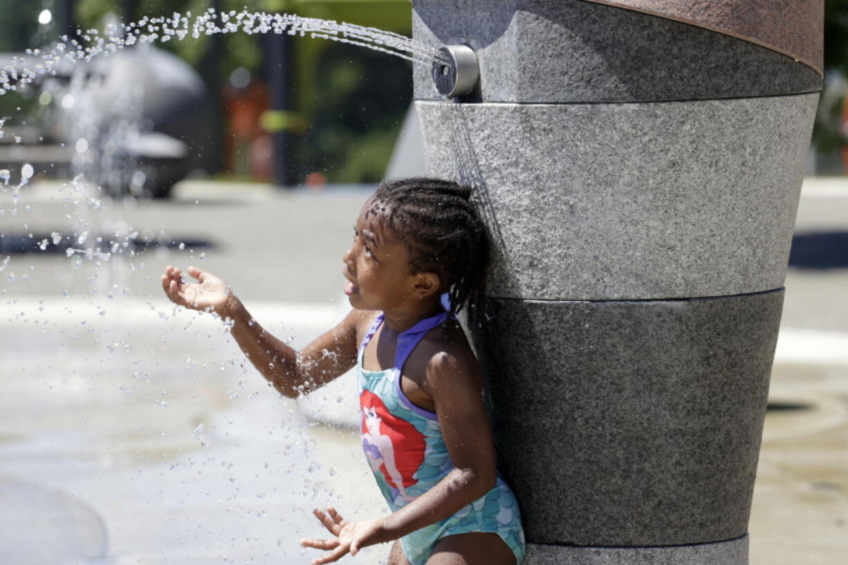 Mellena O'Brien, 4, plays in the Yesler TerraceSpray Park during a heat wave hitting the Pacific Northwest, Sunday, June 27, 2021, in Seattle. Yesterday set a record high for the day with more record highs expected today and Monday.