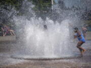 While Portland reached a record temperature of over 110 degrees Sunday, June 27, 2021 people gathered at Salmon Street Springs water fountain in Portland to cool off.