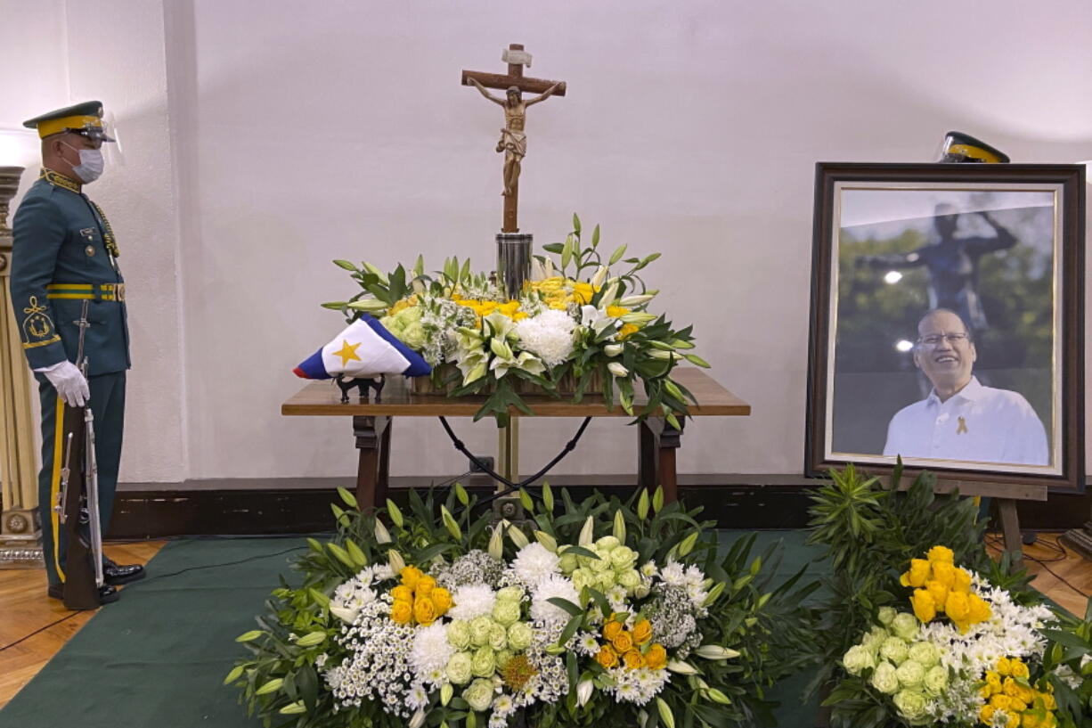 Honor guards stand next to the urn of former Philippine President Benigno Aquino III at the Heritage Memorial Park in Taguig, Philippines on Thursday, June 24, 2021. Aquino, the son of pro-democracy icons who helped topple dictator Ferdinand Marcos and had troublesome ties with China, died Thursday, a cousin and public officials said. He was 61.