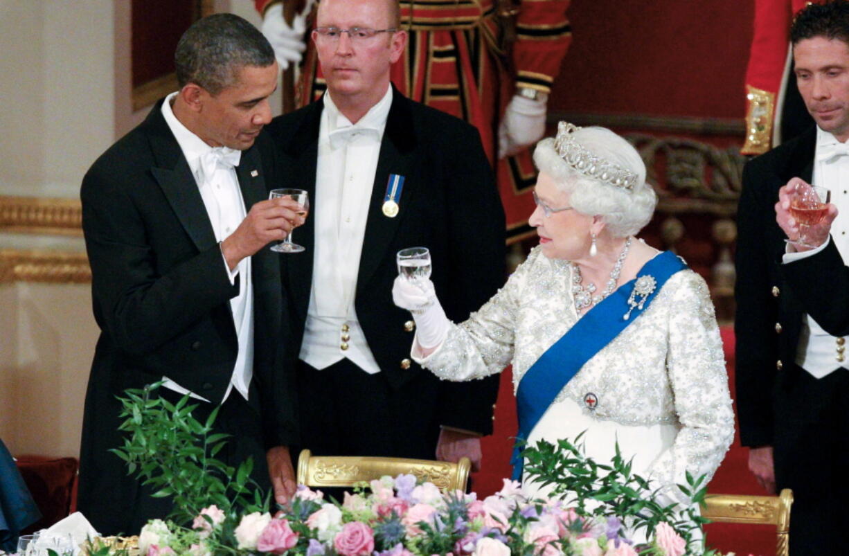 FILE - In this May 24, 2011, file photo Queen Elizabeth II, and U.S. President Barack Obama attend a state banquet in Buckingham Palace, London.