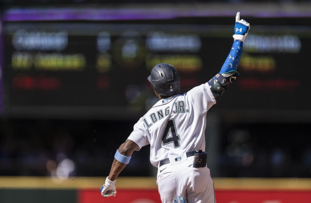 Seattle Mariners' Shed Long Jr. celebrates as he rounds the bases after hitting a grand slam off Tampa Bay Rays relief pitcher Diego Castillo that also scored Luis Torrens, Dylan Moore and Jake Bauers during the 10th inning of a baseball game, Sunday, June 20, 2021, in Seattle.