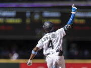 Seattle Mariners' Shed Long Jr. celebrates as he rounds the bases after hitting a grand slam off Tampa Bay Rays relief pitcher Diego Castillo that also scored Luis Torrens, Dylan Moore and Jake Bauers during the 10th inning of a baseball game, Sunday, June 20, 2021, in Seattle.