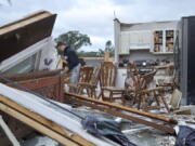 Nathan Casey, 16, surveys the damage of his home after a tornado swept through the area in Woodridge, Ill., Monday June 21, 2021.