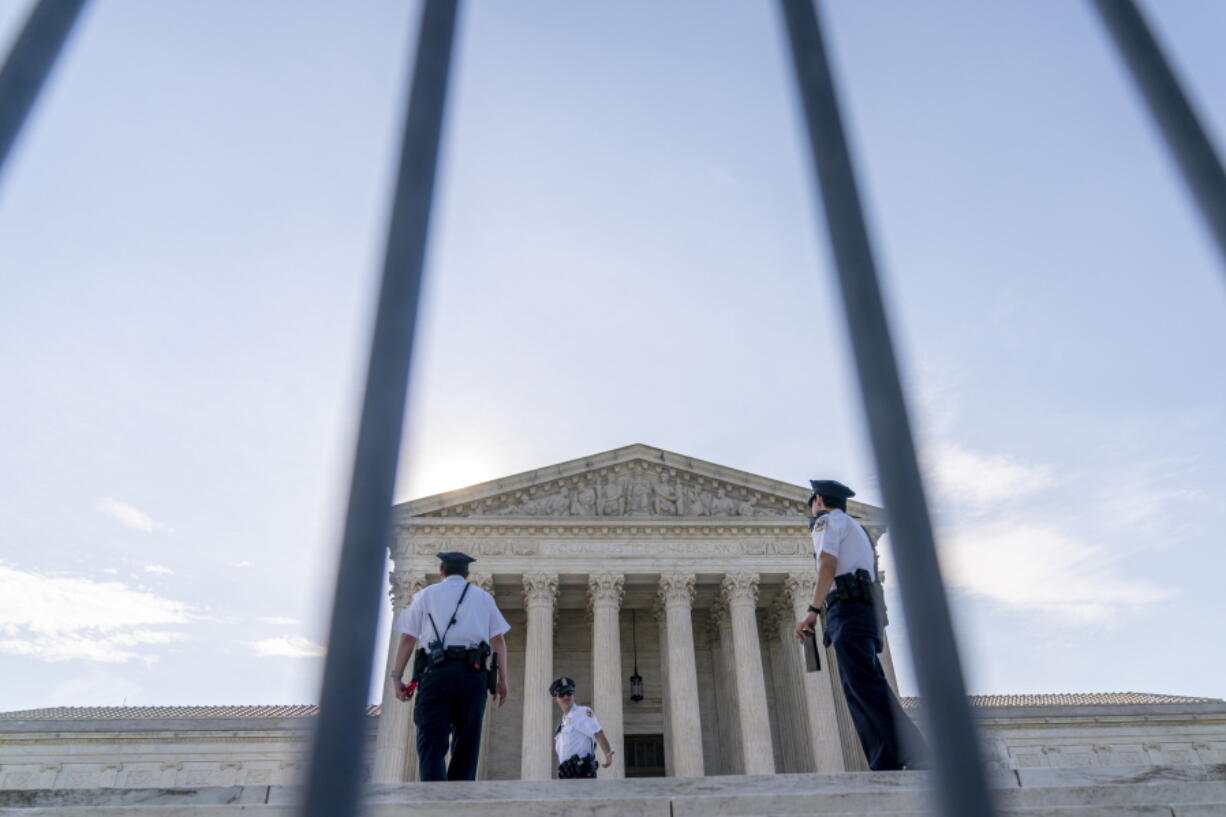 The Supreme Court is seen through a police barricade in Washington, Monday, June 7, 2021.