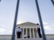 The Supreme Court is seen through a police barricade in Washington, Monday, June 7, 2021.