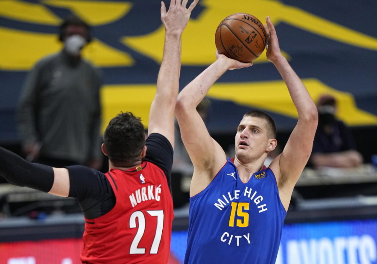 Denver Nuggets center Nikola Jokic (15) shoots against Portland Trail Blazers center Jusuf Nurkic (27) during the first half of Game 5 of a first-round NBA basketball playoff series Tuesday, June 1, 2021, in Denver.