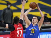 Denver Nuggets center Nikola Jokic (15) shoots against Portland Trail Blazers center Jusuf Nurkic (27) during the first half of Game 5 of a first-round NBA basketball playoff series Tuesday, June 1, 2021, in Denver.