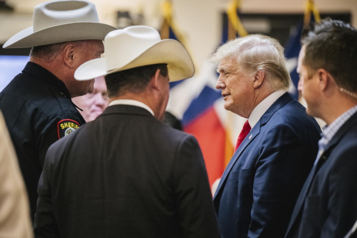 Former President Donald Trump greets law enforcement while arriving at a border security briefing to discuss further plans in securing the southern border wall on Wednesday, June 30, 2021, in Weslaco, Texas.