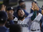 Seattle Mariners' J.P. Crawford celebrates in the dugout after scoring against the Minnesota Twins during the sixth inning of a baseball game Tuesday, June 15, 2021, in Seattle.