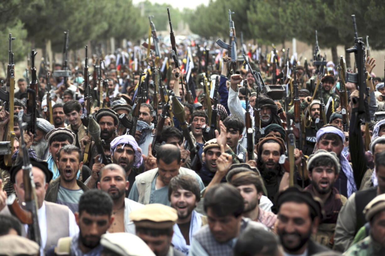 In this June 23, 2021, photo, Afghan militiamen join Afghan defense and security forces during a gathering in Kabul, Afghanistan. U.S. officials tell The Associated Press that about 650 U.S. troops are expected to be kept in Afghanistan to provide security for the American diplomatic presence after the Pentagon completes its military withdrawal, which is set to be largely done in the next two weeks.