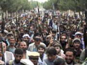 In this June 23, 2021, photo, Afghan militiamen join Afghan defense and security forces during a gathering in Kabul, Afghanistan. U.S. officials tell The Associated Press that about 650 U.S. troops are expected to be kept in Afghanistan to provide security for the American diplomatic presence after the Pentagon completes its military withdrawal, which is set to be largely done in the next two weeks.