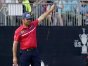 Louis Oosthuizen, of South Africa, reacts to making his eagle putt on the 18th green during the third round of the U.S. Open Golf Championship, Saturday, June 19, 2021, at Torrey Pines Golf Course in San Diego.