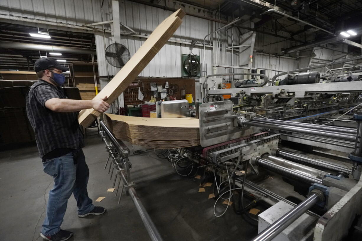 Rob Bondurant, a supervisor at Great Southern Industries, a packaging company, loads up a finishing machine in the Jackson, Miss., facility, Friday, May 28, 2021. The lack of workers has forced some supervisors to assume additional duties. Charita McCarrol, human resources manager at the company, cites the abuse by some people of the $300-a-week federal supplement for people who lost their jobs during the COVID-19 pandemic, as well as other programs that offered extended support for the unemployed, with providing a soon to end financial staple. She also cited that for some people, a steady paycheck and benefits like health care, are not enough of an incentive to pass up the expiring benefits. (AP Photo/Rogelio V.