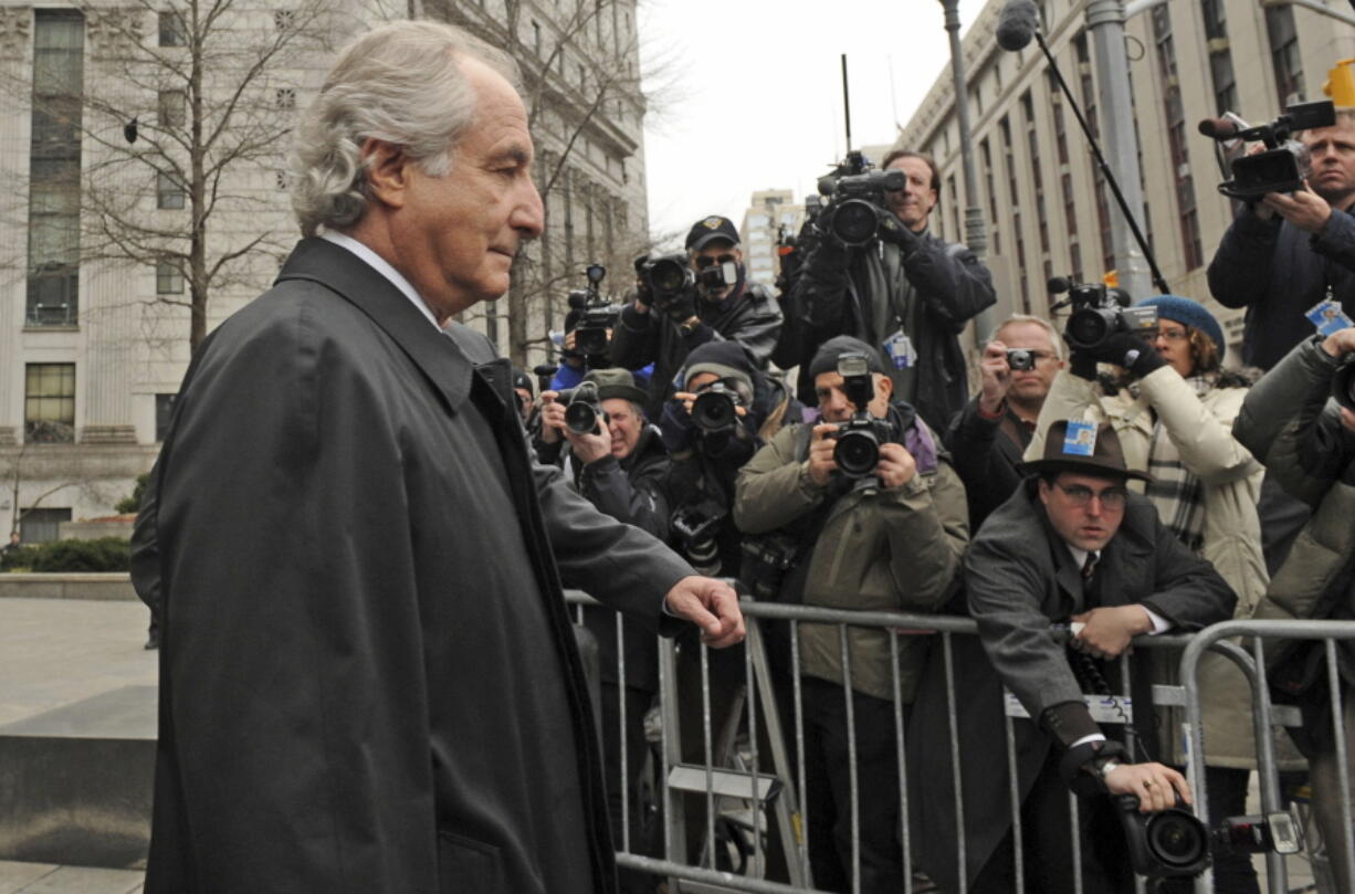 FILE - Bernard Madoff exits Manhattan federal court, Tuesday, March 10, 2009, in New York. The epic Ponzi scheme mastermind  is dead. But the effort to untangle his web of deceit lives on.