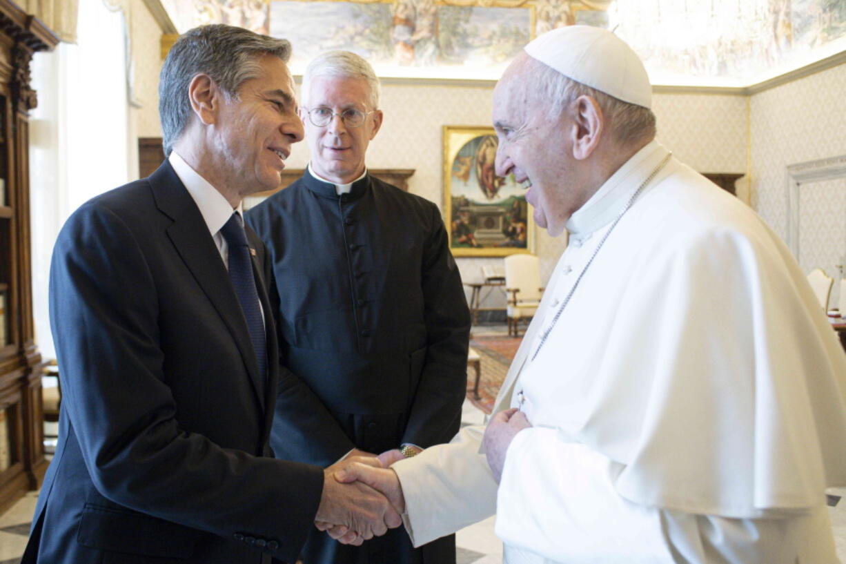 Pope Francis shakes hands with Secretary of State Antony Blinken, as they meet at the Vatican, Monday, June 28, 2021. Blinken is on a week long trip in Europe traveling to Germany, France and Italy.