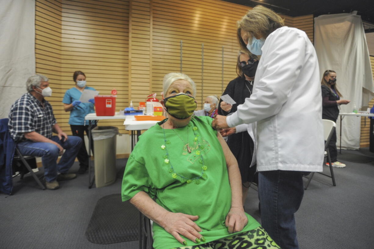 Kristy Stoos receives her COVID-19 inoculation March 17 at Grand Teton Mall in Idaho Falls, Idaho.