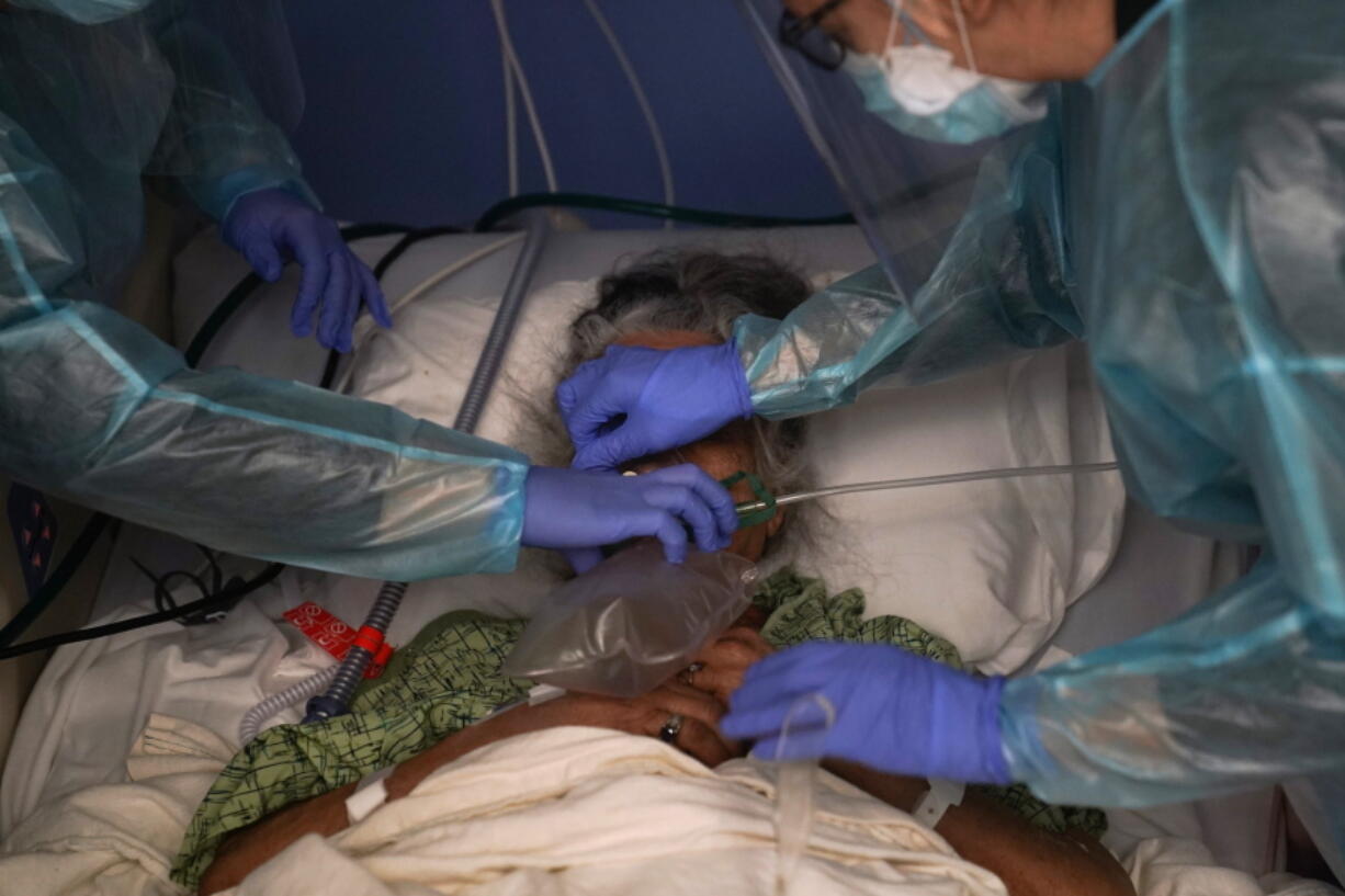 Nurses put a ventilator on a patient Jan. 7 in a COVID-19 unit in Orange, Calif.