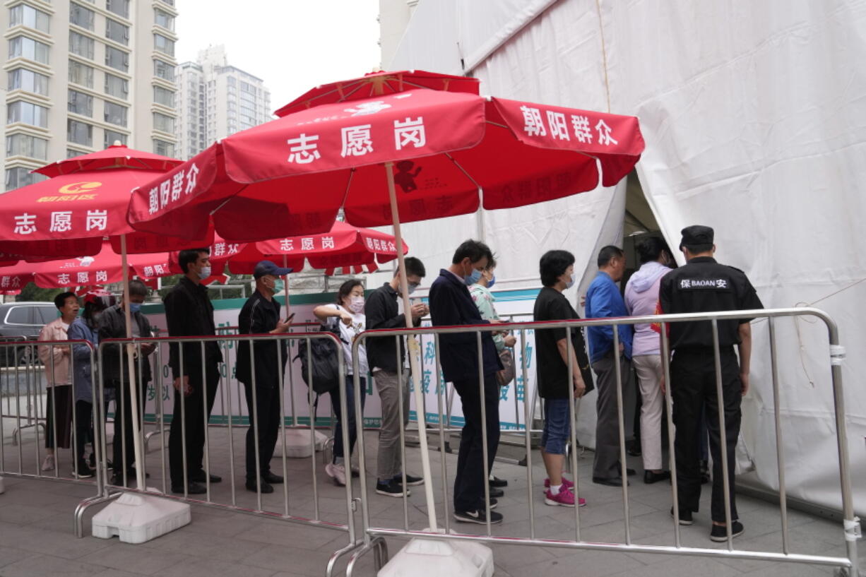 Residents line up outside a vaccination center in Beijing on Wednesday, June 2, 2021. After a slow start, China is now doing what virtually no other country in the world can: harnessing the power and all-encompassing reach of its one-party system and a maturing domestic vaccine industry to administer shots at a staggering pace.