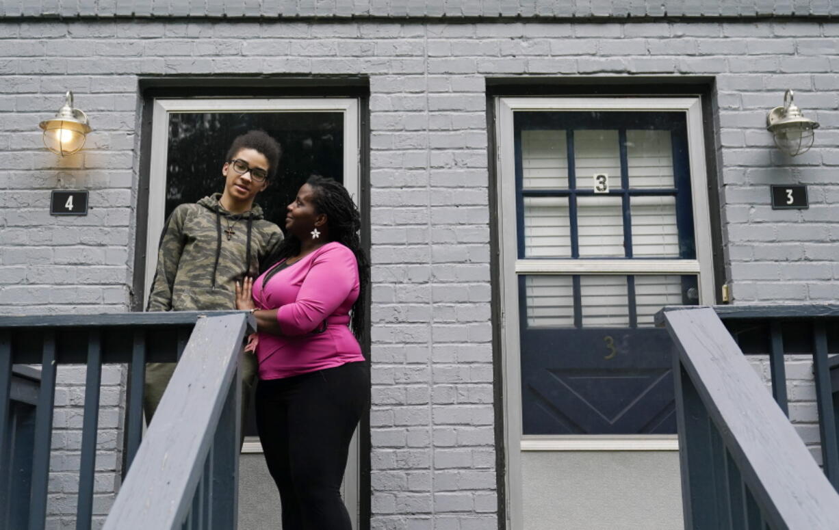 Dylyn Price, right, and her son Devone, 14, both of Athens, Ga., stand outside of their rented townhome on Tuesday, June 22, 2021, in Athens, Ga. A rental crisis spurred by the pandemic prompted many states to make bold promises to help renters, but most failed to deliver on them after Congress passed the sweeping CARES Act in March 2020. Price said she got about $5,800 in rental assistance but that may not prevent her from losing her home. "It's a very nauseating and uncomfortable situation to be in," Price said.