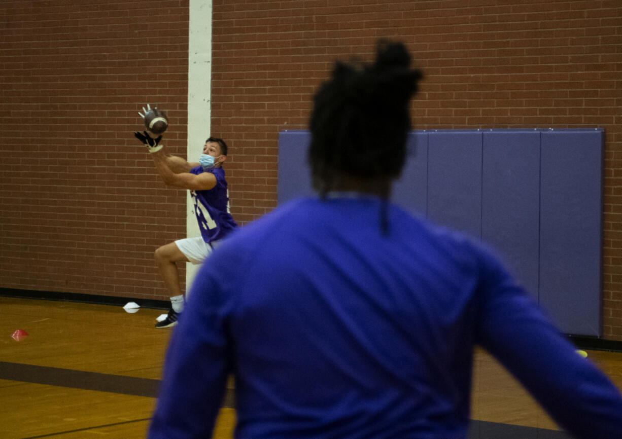 Columbia River football team?s receivers run through a drill on Tuesday, June 29, 2021, at Columbia River High School. As football teams ready for a return to normal this fall, coaches are adjusting to the current and everchanging restrictions, revised schedules and the effects of a season that ended just months ago.