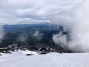 Once reaching the volcano's rim, many hikers ski or glissade several miles down the mountain.