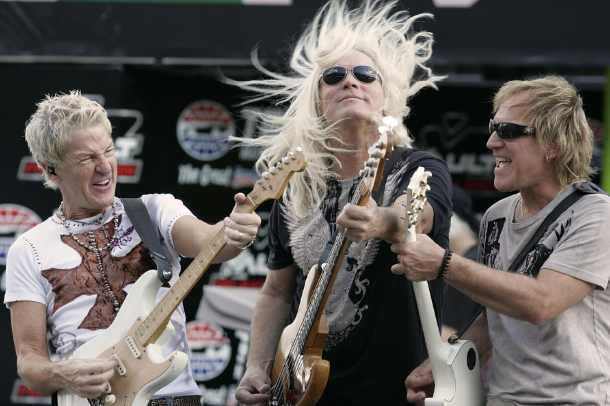 REO Speedwagon members, from left, Kevin Cronin, Bruce Hall, and Dave Amato perform before the start of the NASCAR Sprint Cup Dickies 500 on Nov. 2, 2008, at Texas Motor Speedway in Fort Worth, Texas.