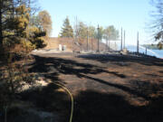 The site of a June 28 fire that burned down a vacant home and the surrounding brush. The cause of the fire is officially undetermined, although the Vancouver Fire Marshal's Office determined the fire started on the exterior of the house.