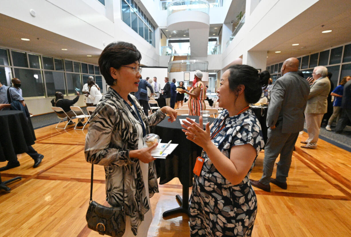 Myeong Hwa Jang, left, talks with Sarah Park, community engagement coordinator, after Gwinnett 101 Citizens Academy's Spring 2021 graduation ceremony at Gwinnett Justice & Administration Center on Tuesday, June 22, 2021.