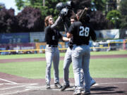 Coby Morales (28),  Caden Connor and Reece Hernandez congratulate John Peck (6)  after Peck hit a three-run home run in the top of the third inning of the Ridgefield Raptors’ 5-2 win over Cowlitz Black Bears on Sunday, July 11, 2021 in Longview (Josh Kirshenbaum/Longview Daily News)