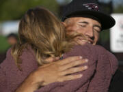 Eli Shubert, pitcher for the Ridgefield Raptors, hugs his mom Vicky Shubert after marrying Erin Thum in a short ceremony on the field before a game against the Port Angeles Lefties at Ridgefield Outdoor Recreation Complex on Wednesday, July 14, 2021.