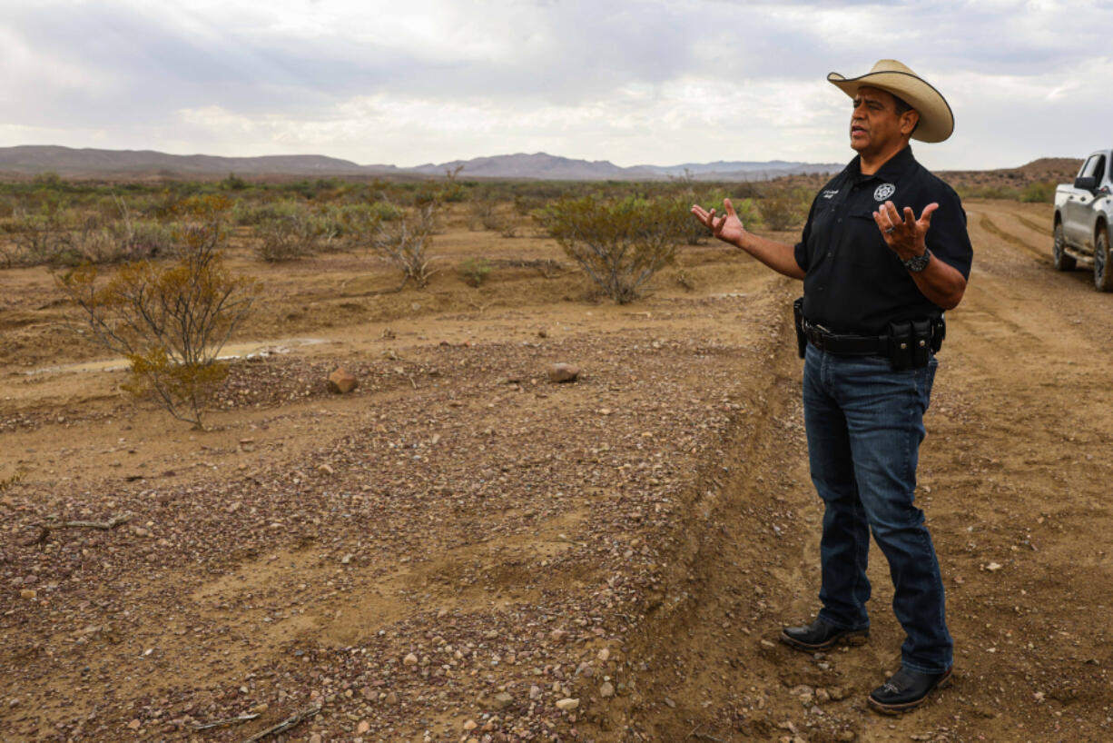 Culberson County Sheriff Oscar Carrillo stands by the spot where the body of 15-year-old boy Christian was found on Thursday, June 24, 2021. Carrillo says they received a distress call from a rancher using a satellite phone on June 21st. The rancher said he had found two migrants in the desert of Texas on Chispa Road in Jeff Davis County. Raul, 35, and his son Christian, 15, both from Ecuador, were crossing the border from Mexico to the U.S. when they got lost after their smuggler abandoned them. Upon deputies' arrival to the scene, Raul was showing signs of severe dehydration, but his son Christian was already deceased.